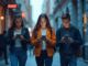 Teens Walking in the City While Using Smartphones